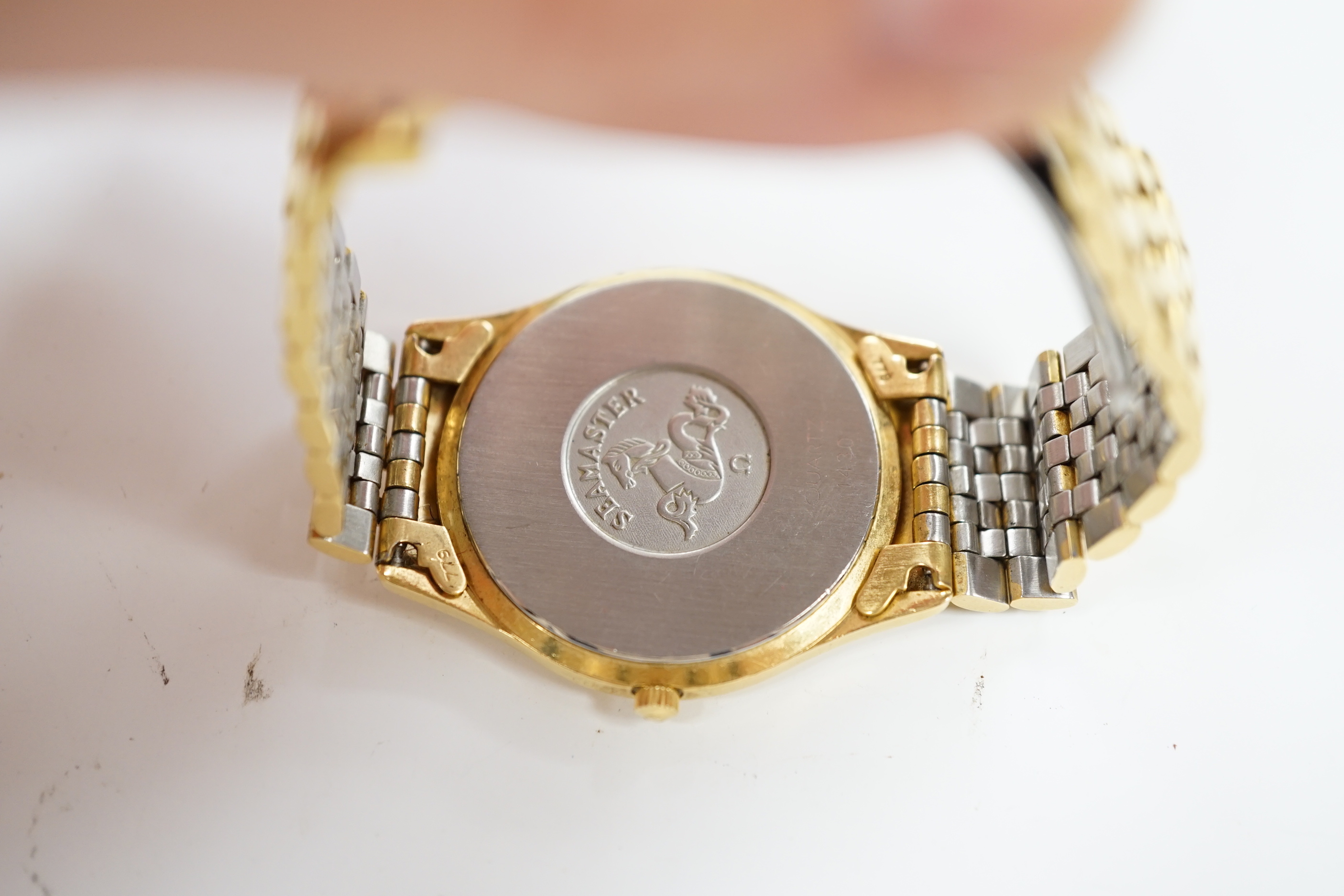 A gentleman’s steel and gold plated Omega Seamaster quartz wristwatch, with box or papers.